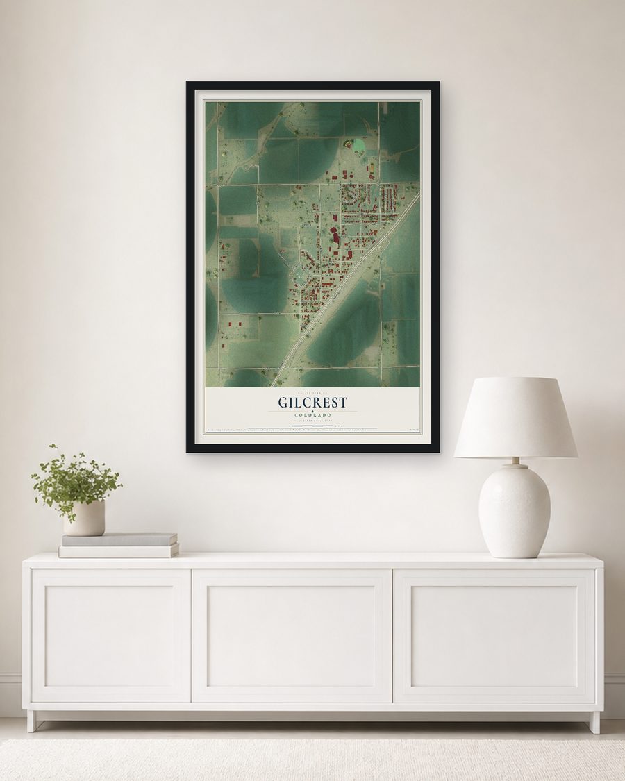 The Gilcrest, Colorado map, 24 x 36 in, in a black wood frame on a living room wall