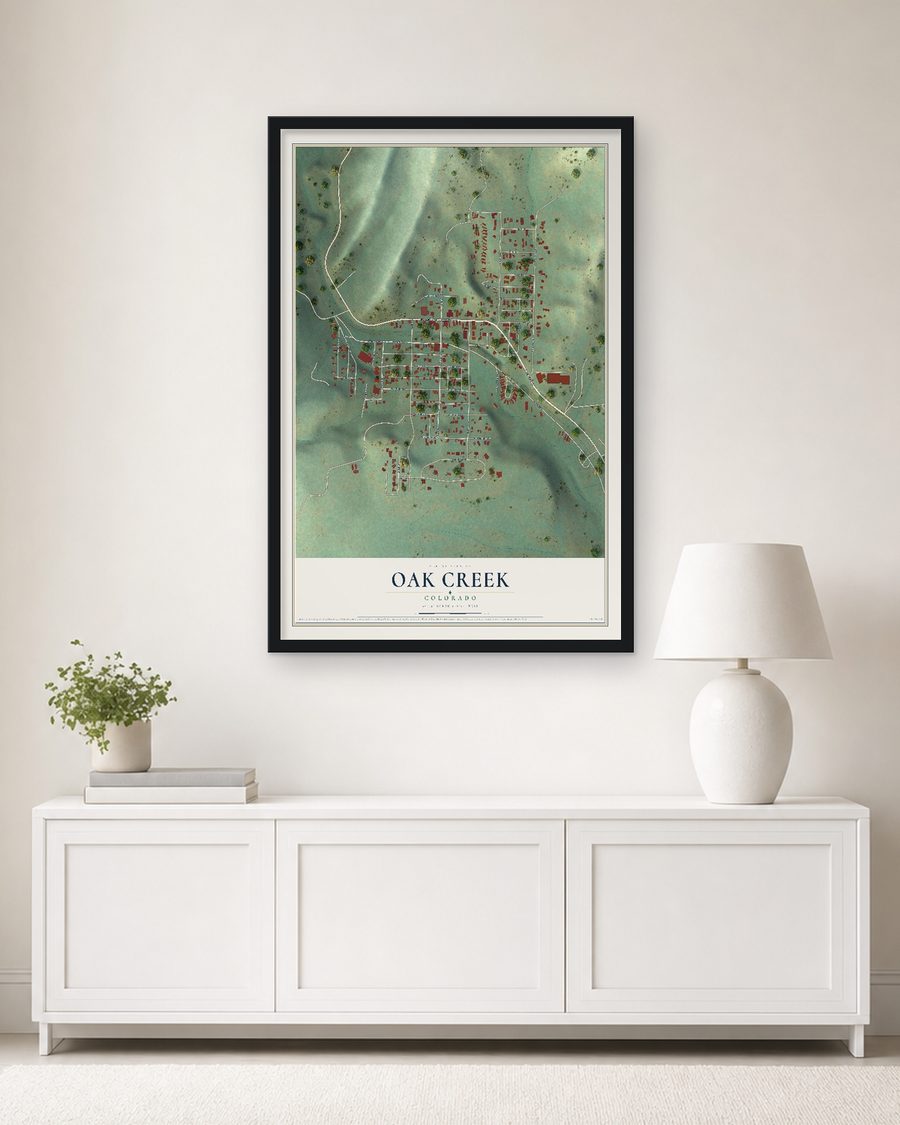 The Oak Creek, Colorado map, 24 x 36 in, in a black wood frame on a living room wall