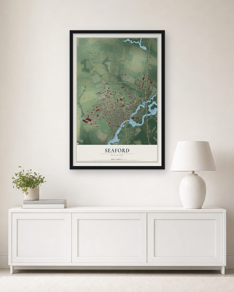 The Seaford, Delaware map, 24 x 36 in, in a black wood frame on a living room wall