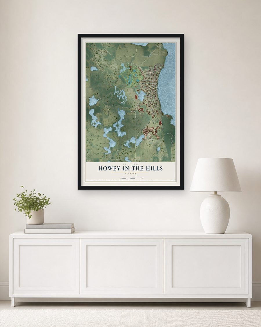 The Howey-in-the-Hills, Florida map, 24 x 36 in, in a black wood frame on a living room wall