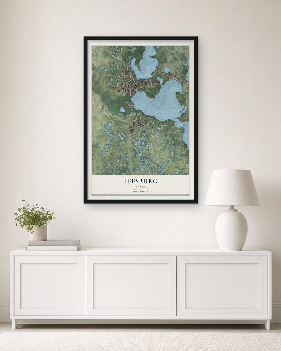 The Leesburg, Florida map, 24 x 36 in, in a black wood frame on a living room wall