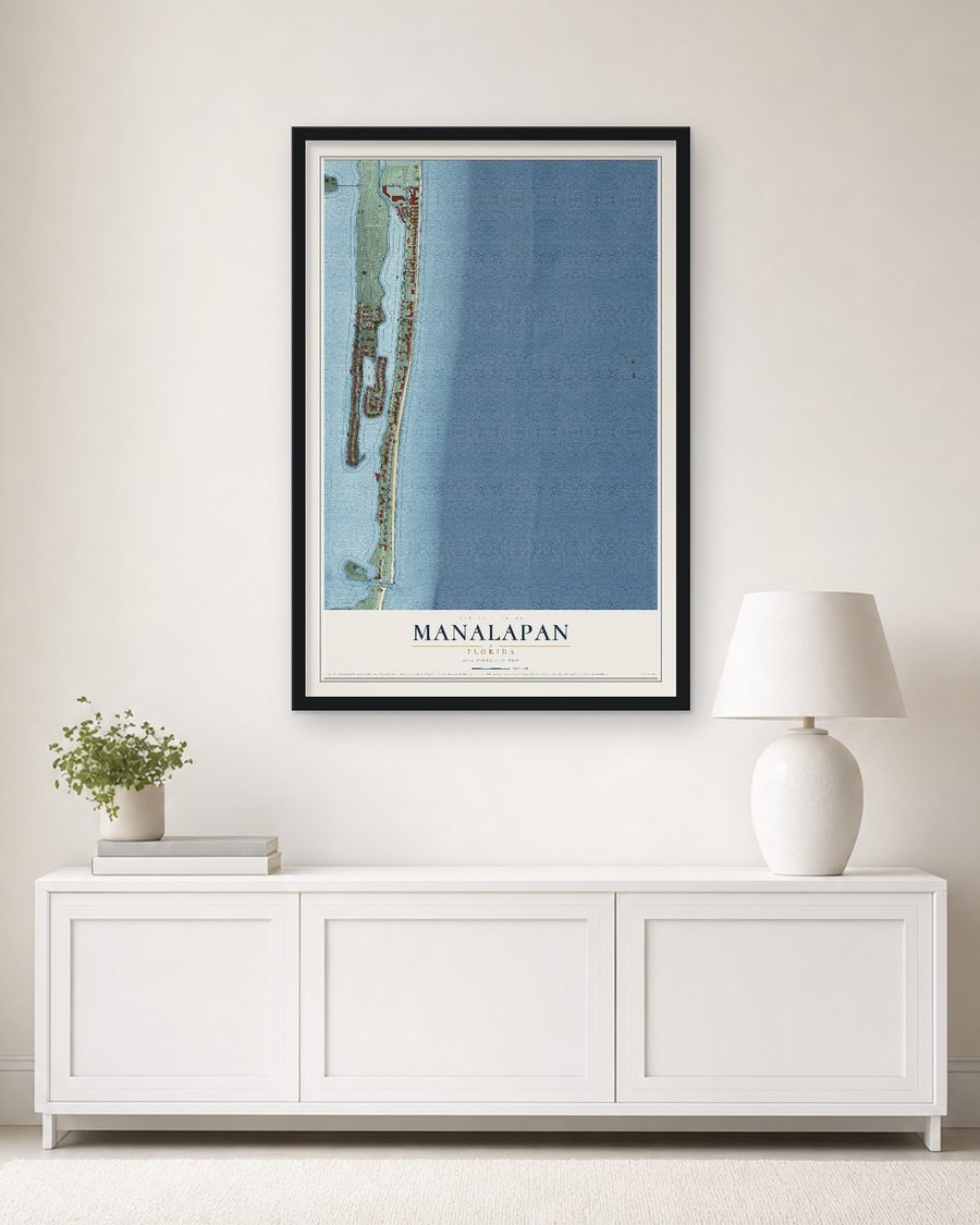The Manalapan, Florida map, 24 x 36 in, in a black wood frame on a living room wall