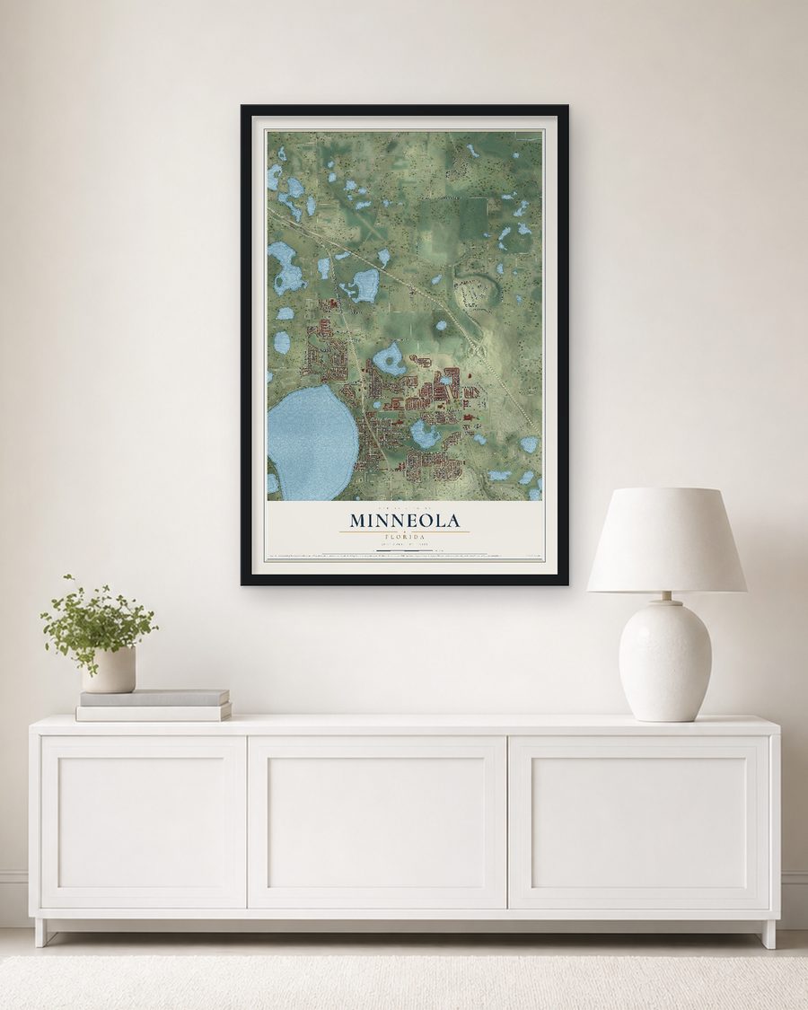 The Minneola, Florida map, 24 x 36 in, in a black wood frame on a living room wall