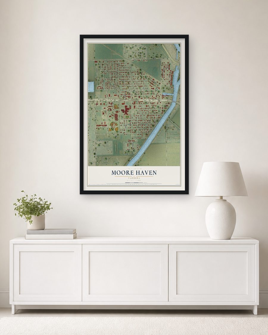 The Moore Haven, Florida map, 24 x 36 in, in a black wood frame on a living room wall