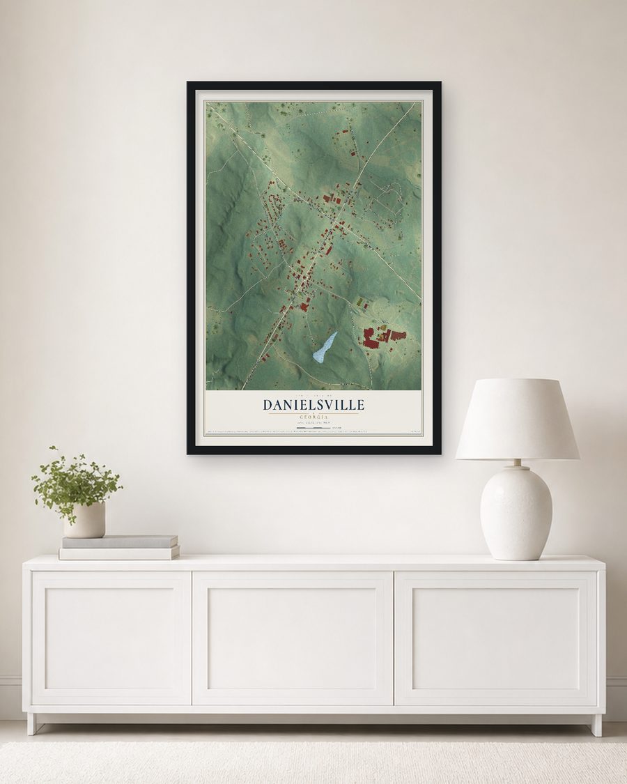 The Danielsville, Georgia map, 24 x 36 in, in a black wood frame on a living room wall
