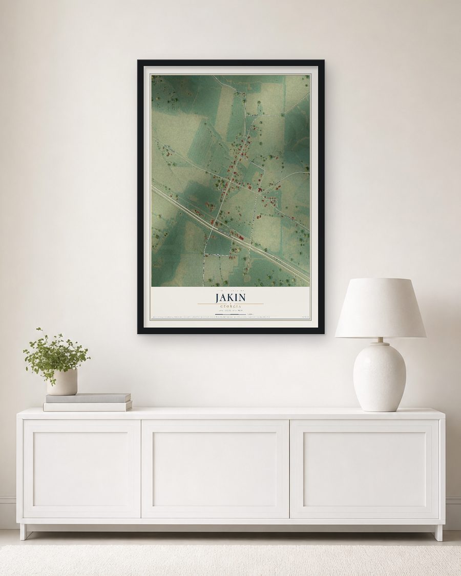 The Jakin, Georgia map, 24 x 36 in, in a black wood frame on a living room wall