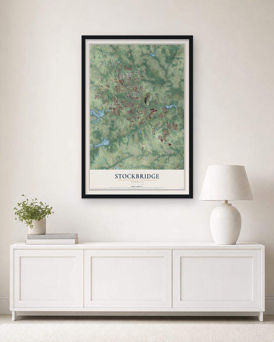 The Stockbridge, Georgia map, 24 x 36 in, in a black wood frame on a living room wall