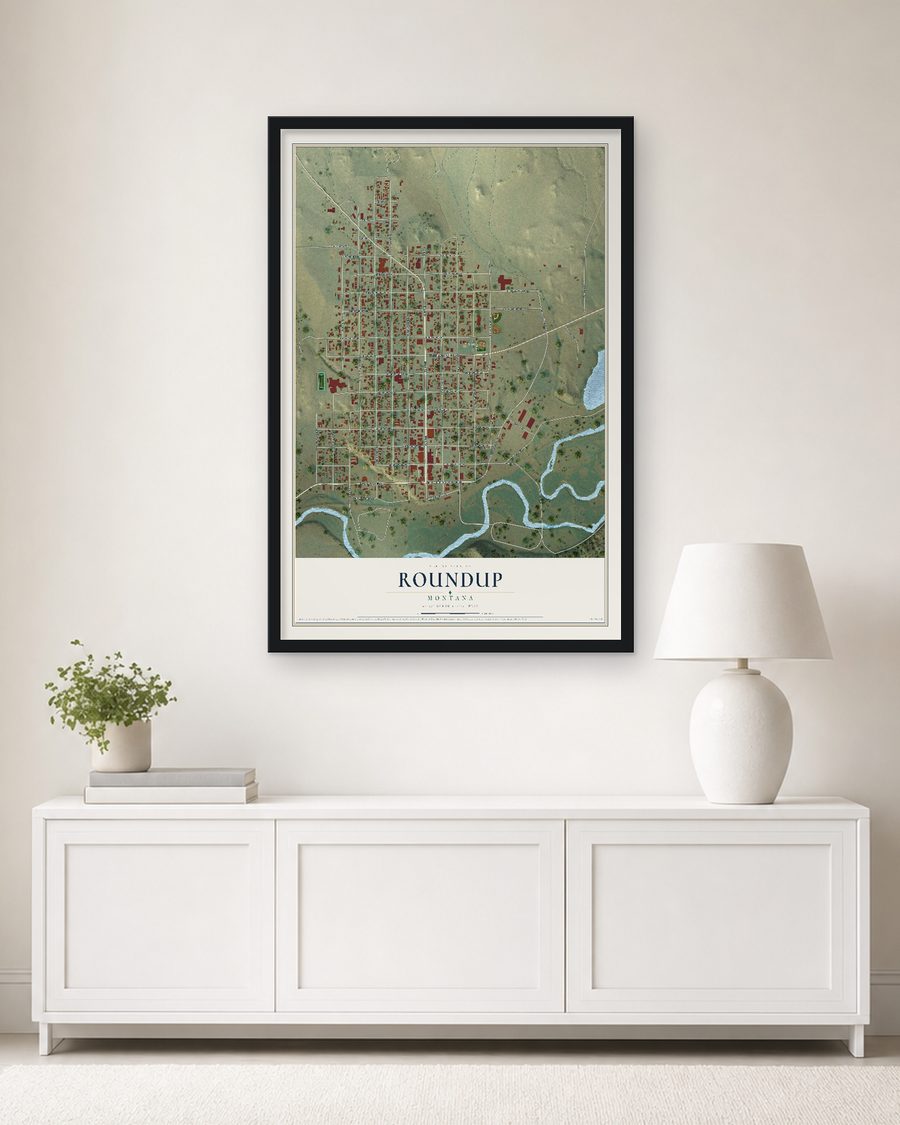 The Roundup, Montana map, 24 x 36 in, in a black wood frame on a living room wall