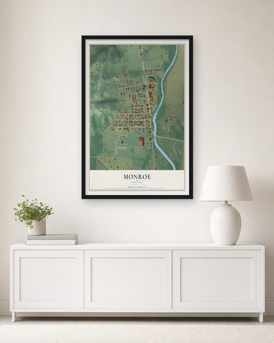 The Monroe, Oregon map, 24 x 36 in, in a black wood frame on a living room wall