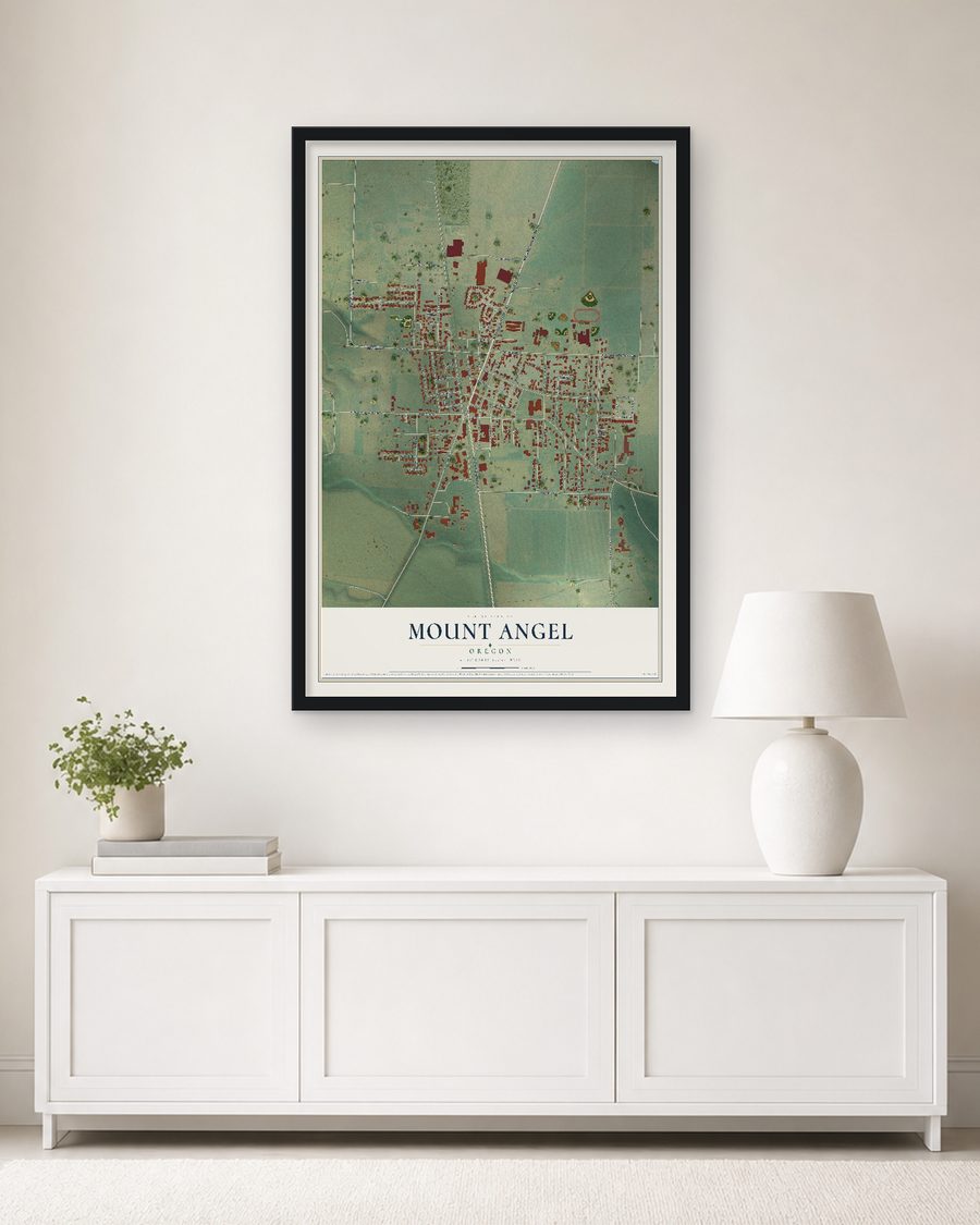 The Mount Angel, Oregon map, 24 x 36 in, in a black wood frame on a living room wall