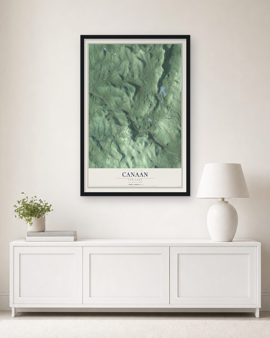 The Canaan, New York map, 24 x 36 in, in a black wood frame on a living room wall