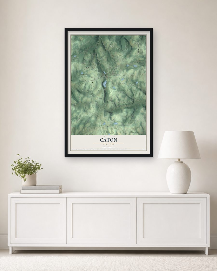 The Caton, New York map, 24 x 36 in, in a black wood frame on a living room wall
