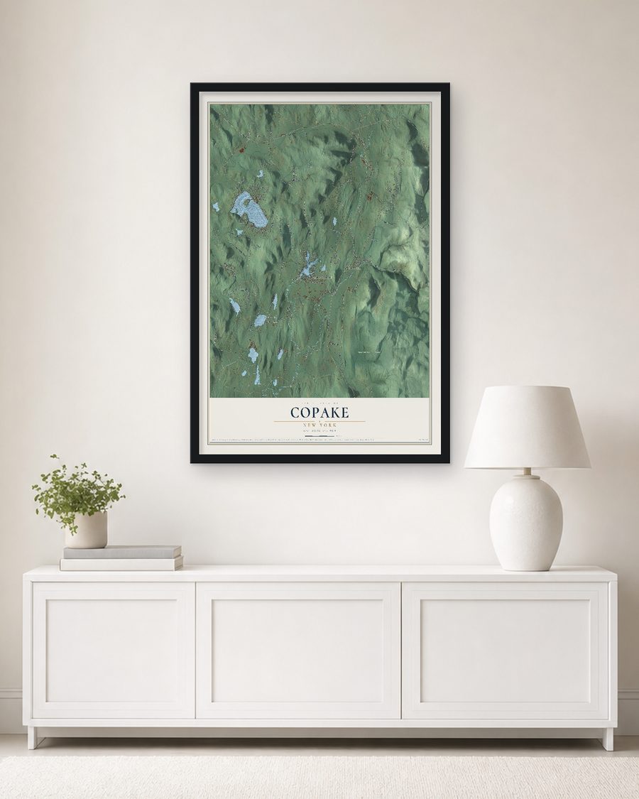 The Copake, New York map, 24 x 36 in, in a black wood frame on a living room wall