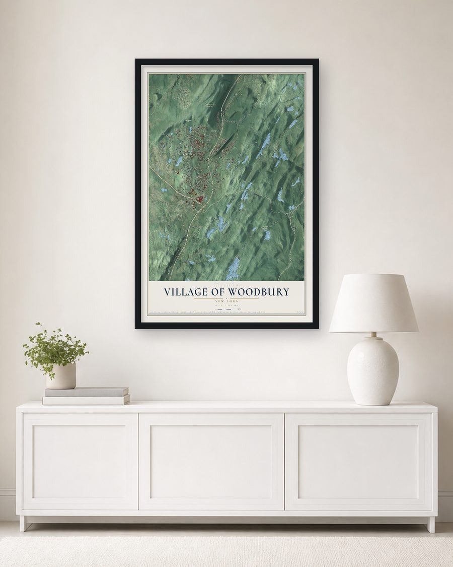 The Village of Woodbury, New York map, 24 x 36 in, in a black wood frame on a living room wall