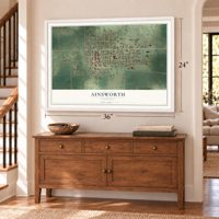 Ainsworth, Nebraska map, 24 x 36 inch print in a white frame above a dresser by a staircase