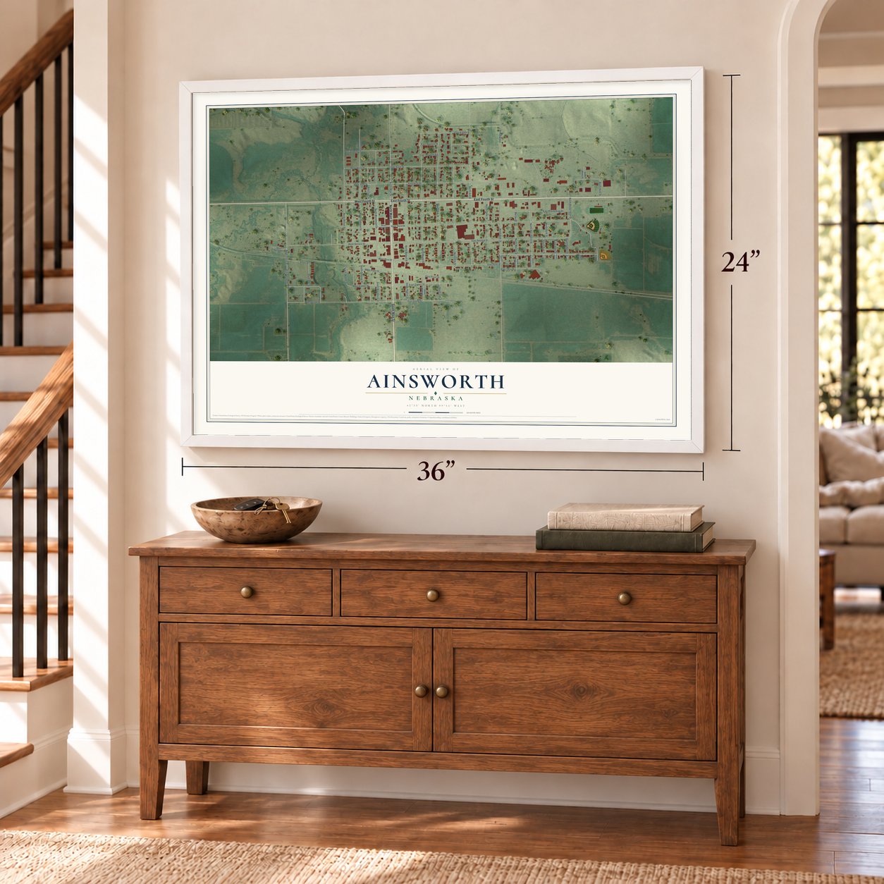 Ainsworth, Nebraska map, 24 x 36 inch print in a white frame above a dresser by a staircase