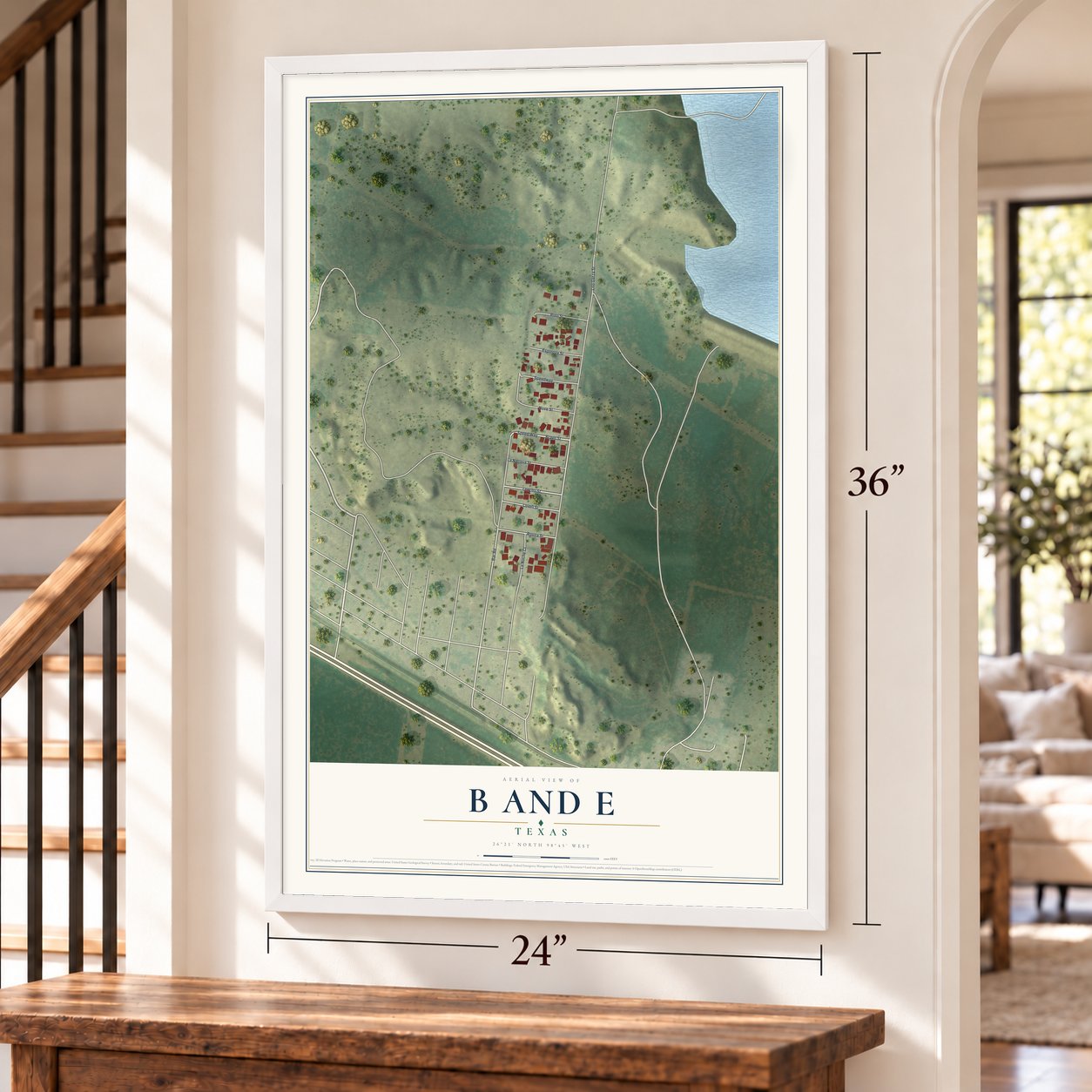 B and E, Texas map, 24 x 36 inch print in a white frame by a staircase