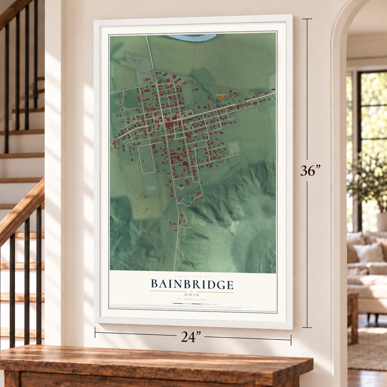 Bainbridge, Ohio map, 24 x 36 inch print in a white frame by a staircase