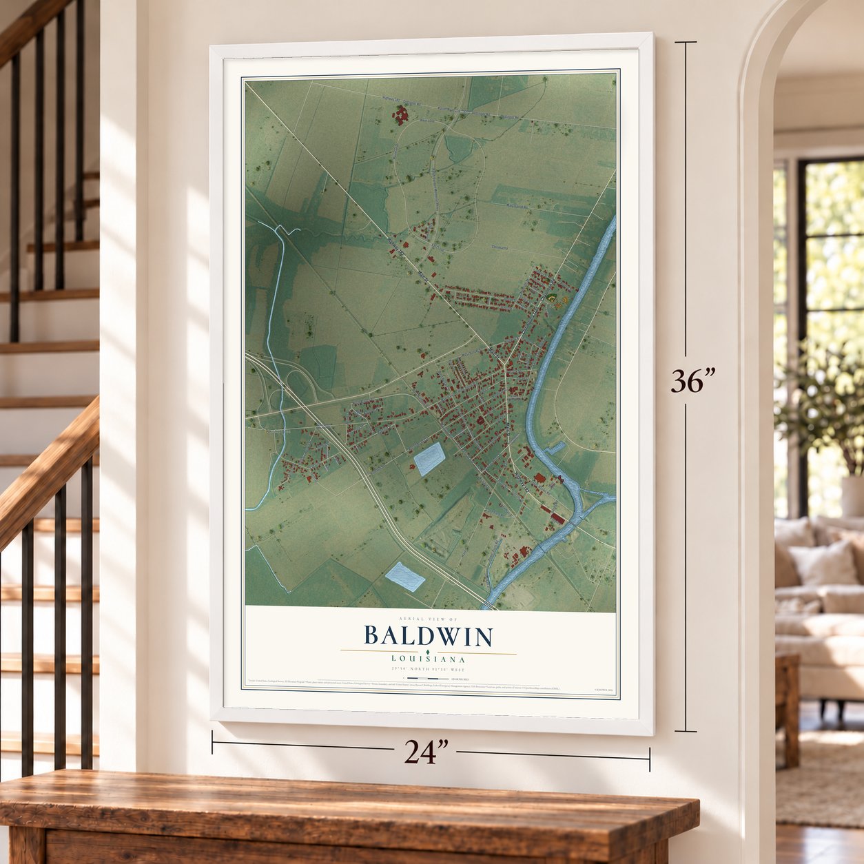 Baldwin, Louisiana map, 24 x 36 inch print in a white frame by a staircase