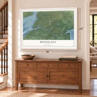 Bristol Bay, Alaska map, 24 x 36 inch print in a white frame above a dresser by a staircase