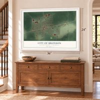 Bronson, Michigan map, 24 x 36 inch print in a white frame above a dresser by a staircase