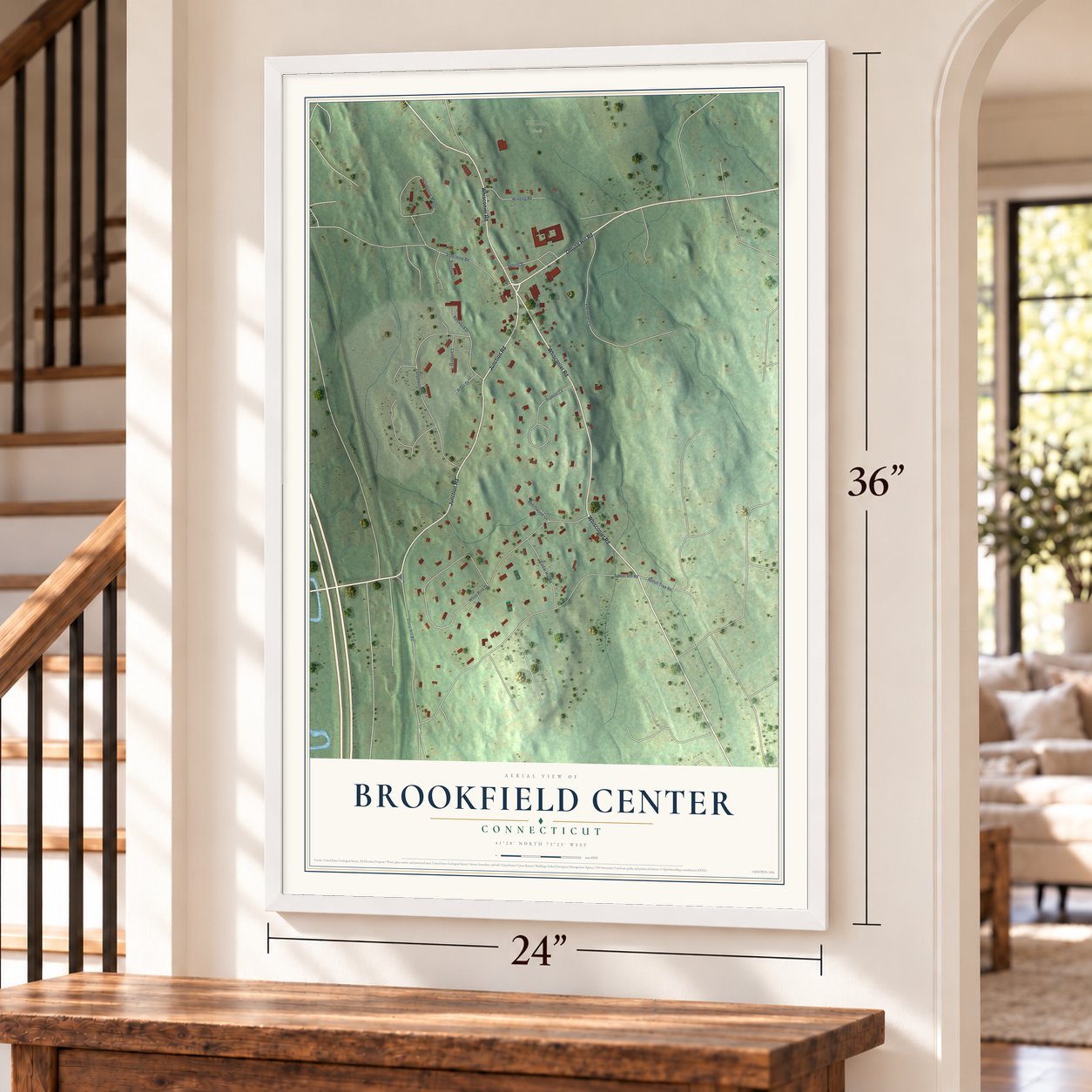 Brookfield Center, Connecticut map, 24 x 36 inch print in a white frame by a staircase
