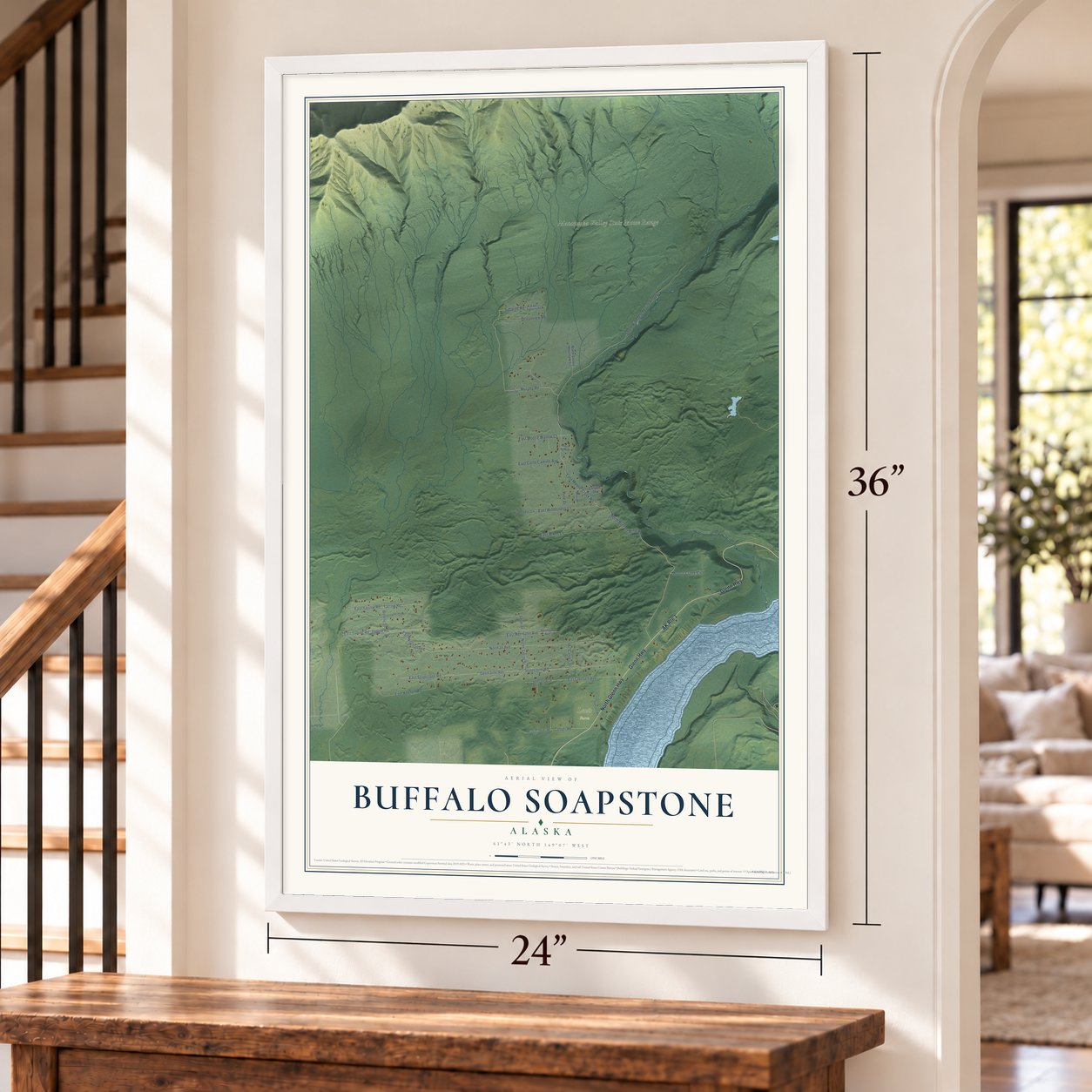 Buffalo Soapstone, Alaska map, 24 x 36 inch print in a white frame by a staircase