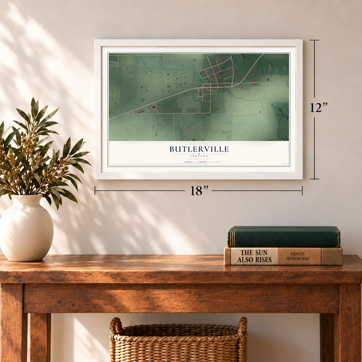 Butlerville, Indiana map, 12 x 18 inch print in a white frame in an entryway