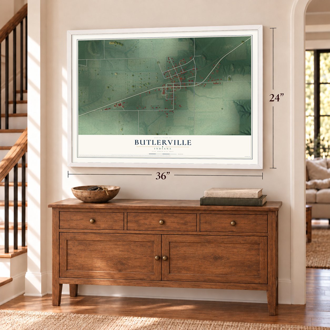 Butlerville, Indiana map, 24 x 36 inch print in a white frame above a dresser by a staircase