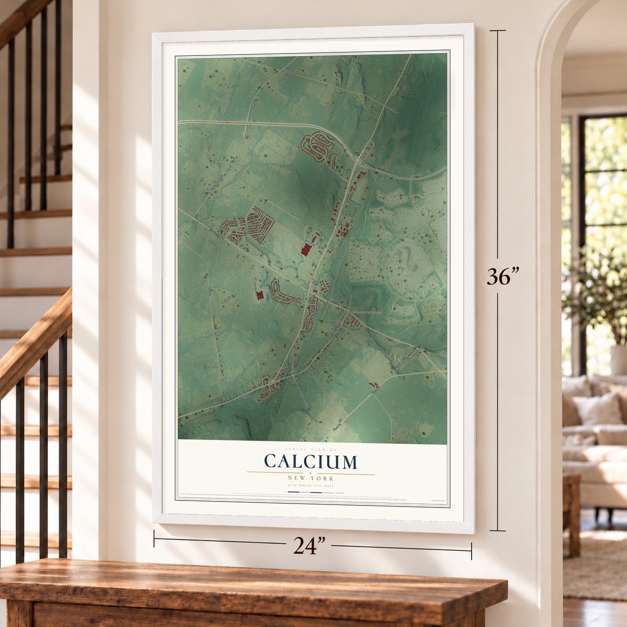 Calcium, New York map, 24 x 36 inch print in a white frame by a staircase