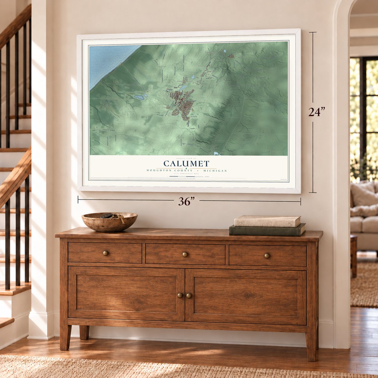 Calumet, Houghton County, Michigan map, 24 x 36 inch print in a white frame above a dresser by a staircase