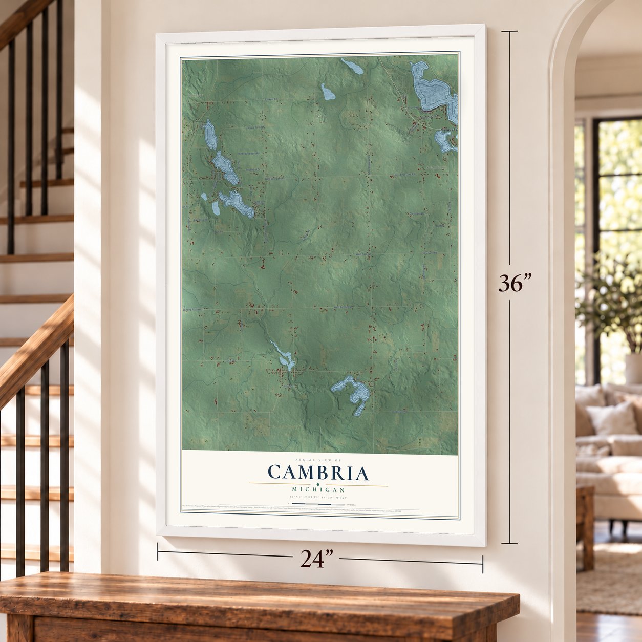 Cambria, Michigan map, 24 x 36 inch print in a white frame by a staircase