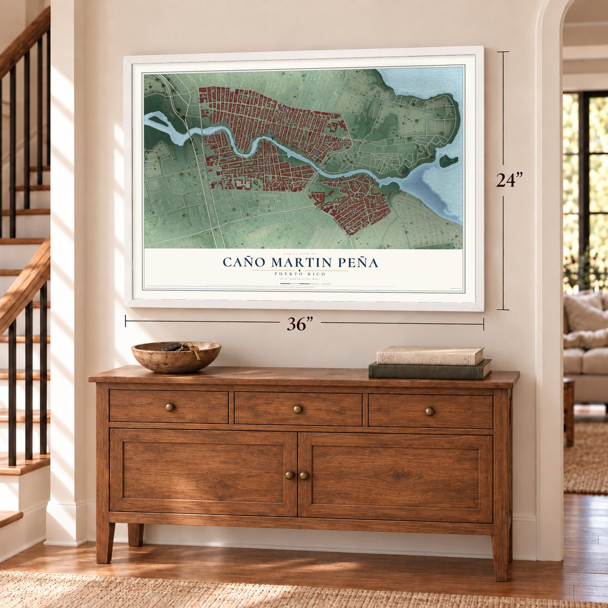 Caño Martin Peña, Puerto Rico map, 24 x 36 inch print in a white frame above a dresser by a staircase