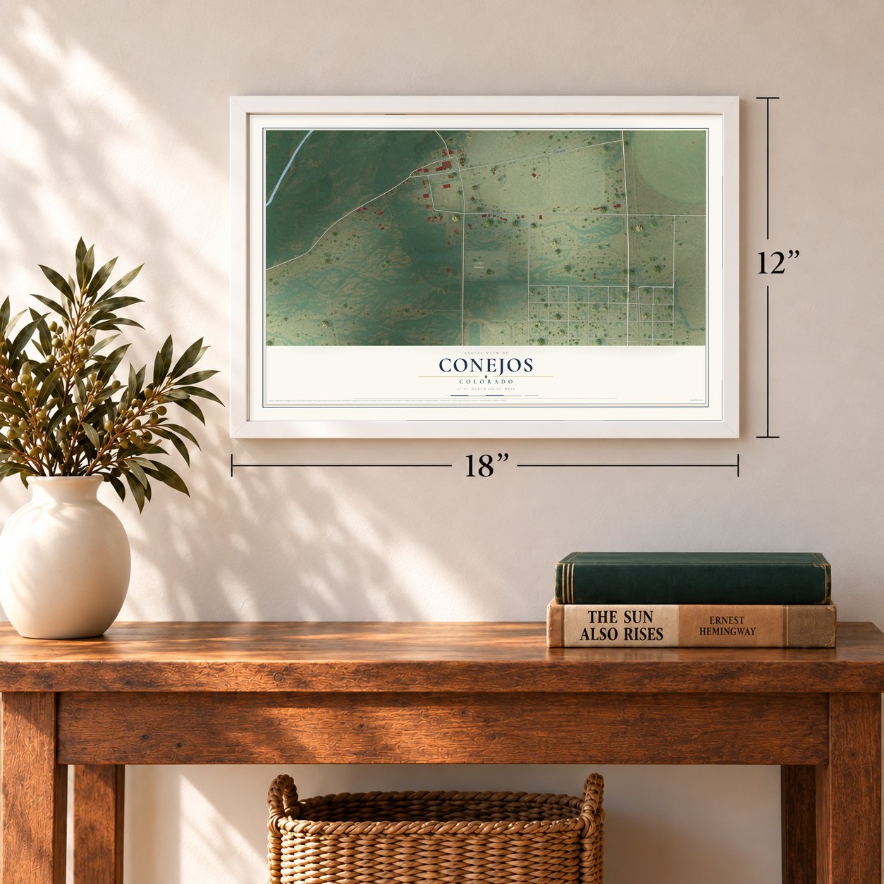 Conejos, Colorado map, 12 x 18 inch print in a white frame in an entryway