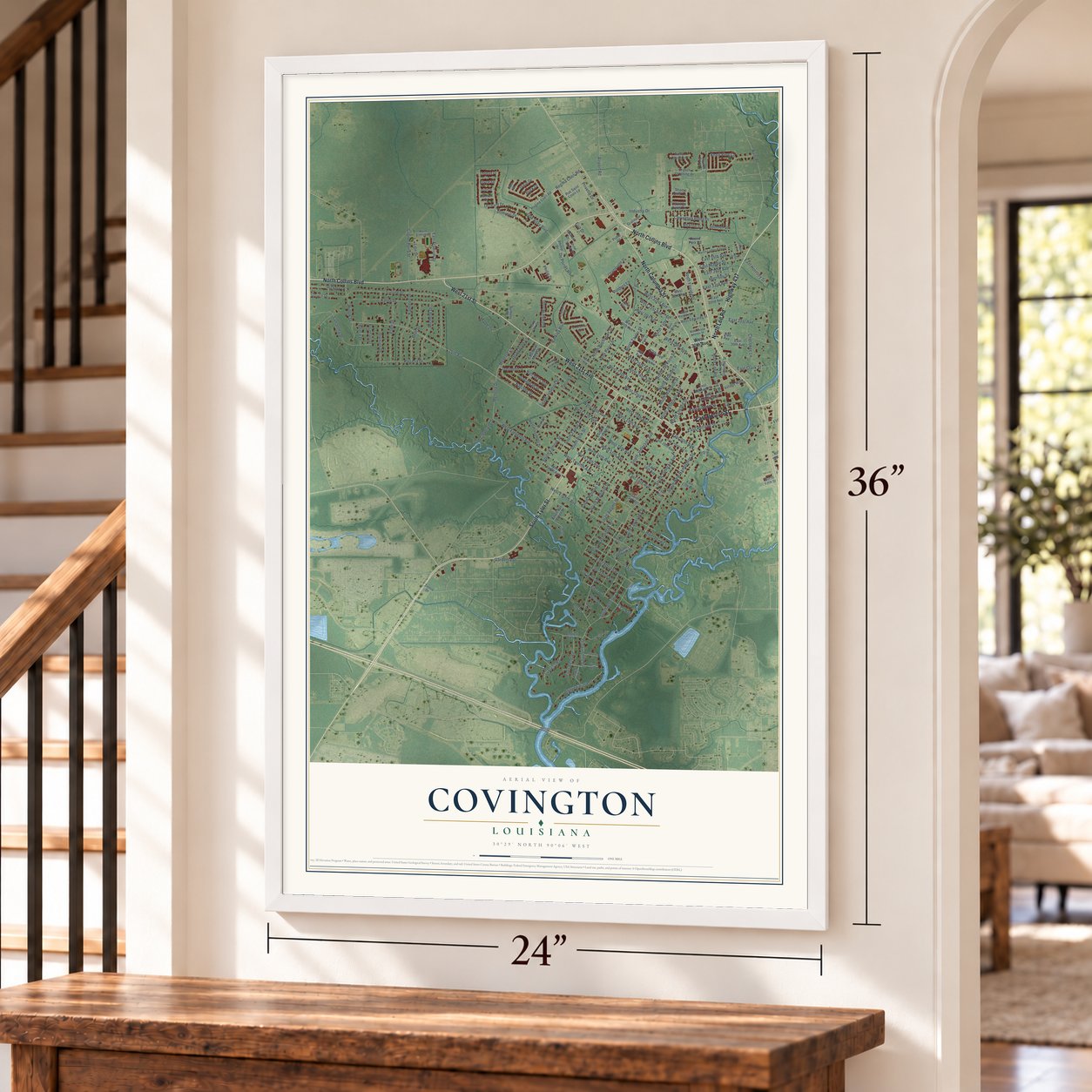 Covington, Louisiana map, 24 x 36 inch print in a white frame by a staircase