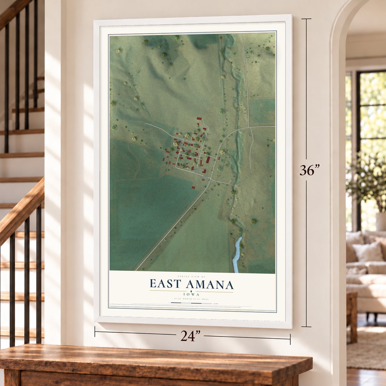 East Amana, Iowa map, 24 x 36 inch print in a white frame by a staircase