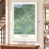 East Bay, Michigan map, 24 x 36 inch print in a white frame by a staircase
