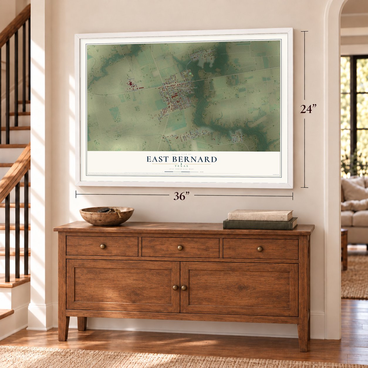 East Bernard, Texas map, 24 x 36 inch print in a white frame above a dresser by a staircase