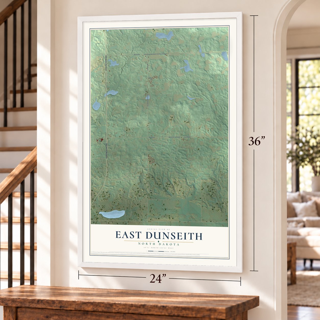 East Dunseith, North Dakota map, 24 x 36 inch print in a white frame by a staircase