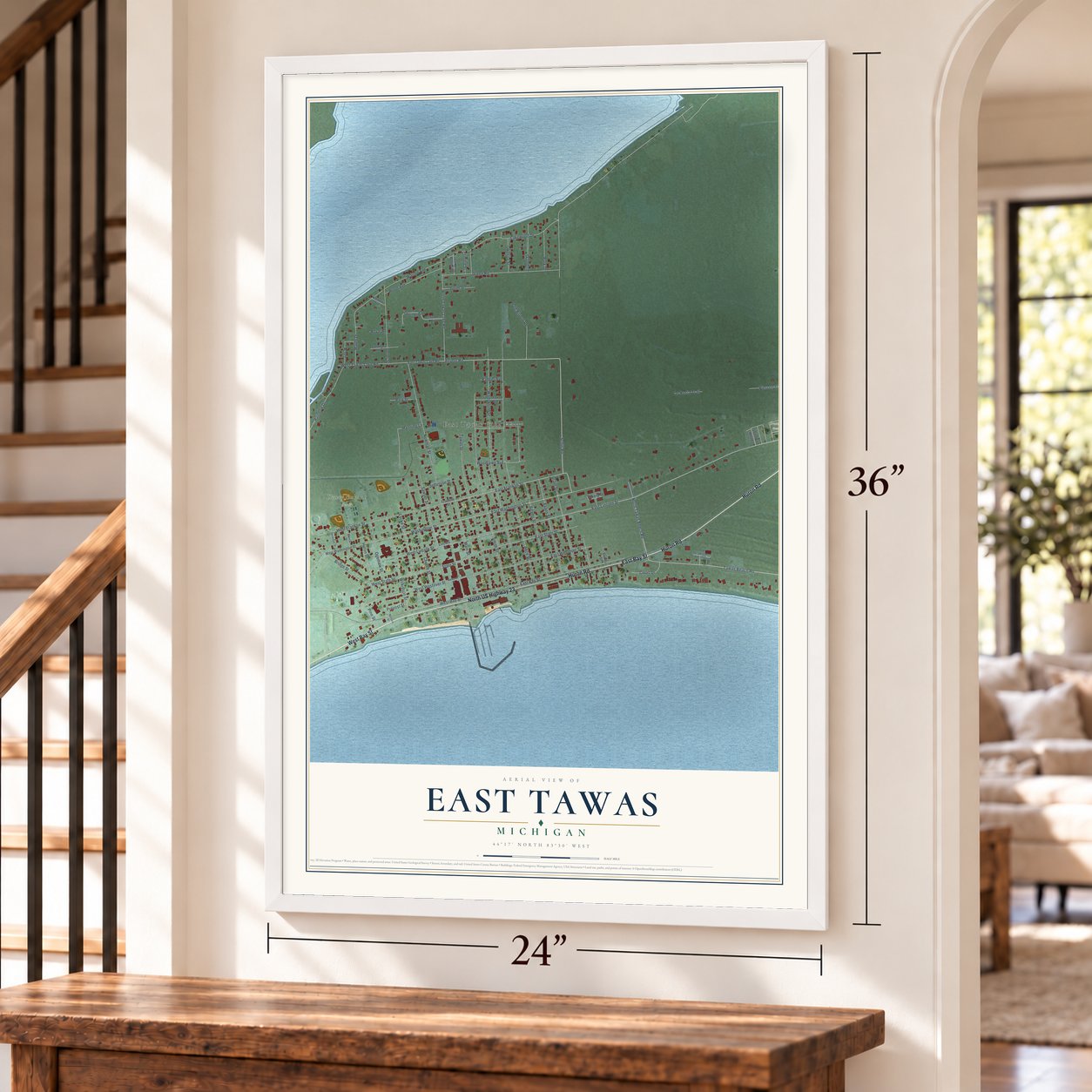 East Tawas, Michigan map, 24 x 36 inch print in a white frame by a staircase