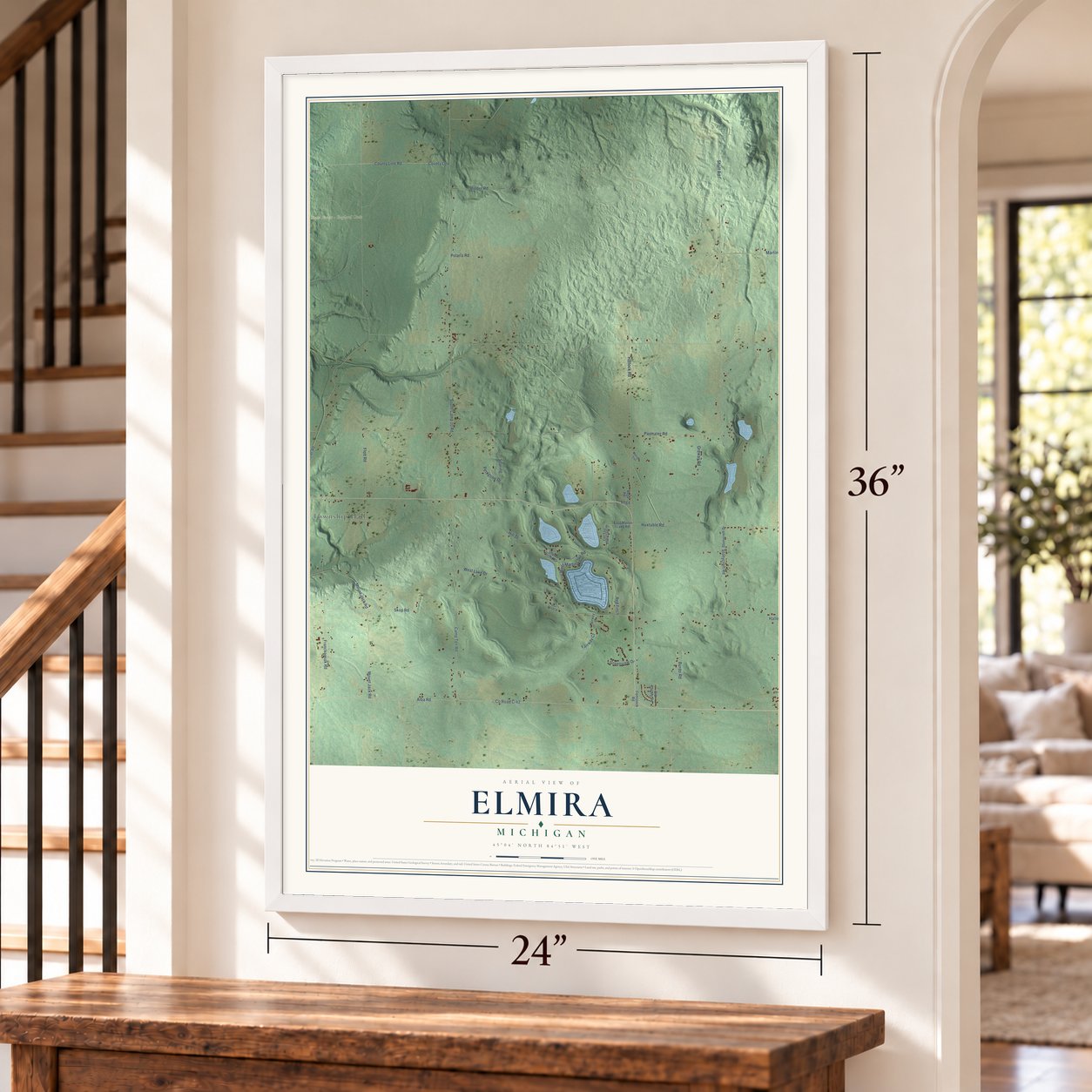 Elmira, Michigan map, 24 x 36 inch print in a white frame by a staircase