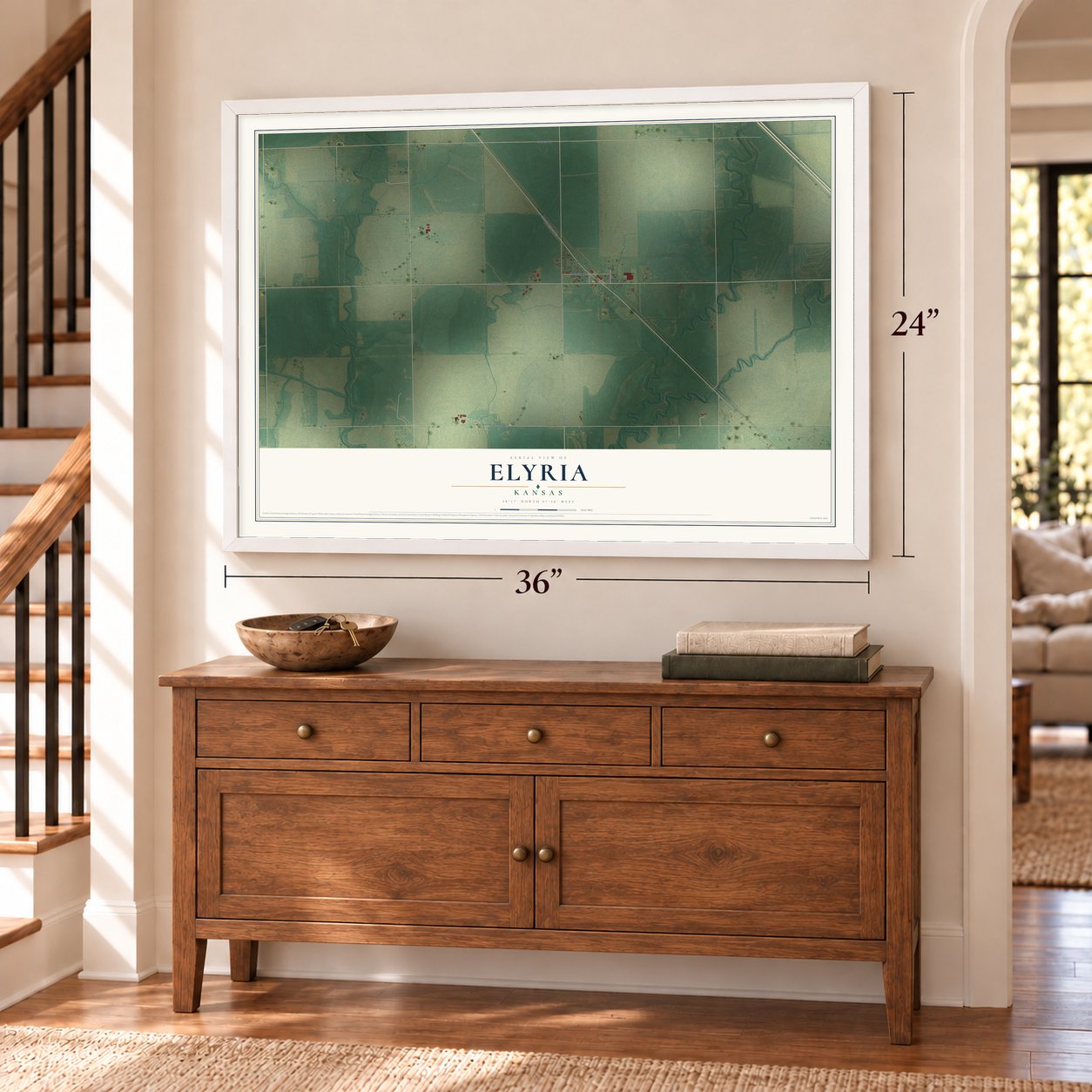 Elyria, Kansas map, 24 x 36 inch print in a white frame above a dresser by a staircase
