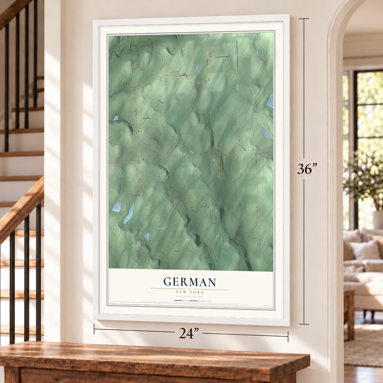 German, New York map, 24 x 36 inch print in a white frame by a staircase