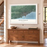 Grand Marais, Minnesota map, 24 x 36 inch print in a white frame above a dresser by a staircase