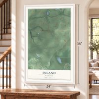 Inland, Michigan map, 24 x 36 inch print in a white frame by a staircase