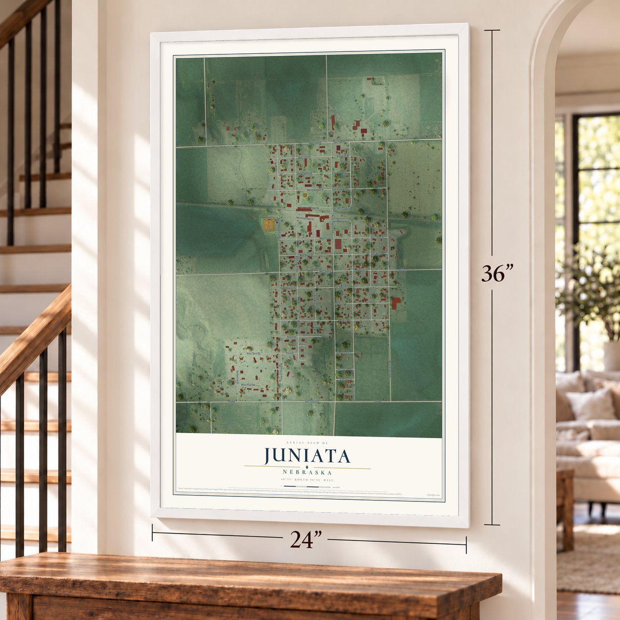 Juniata, Nebraska map, 24 x 36 inch print in a white frame by a staircase