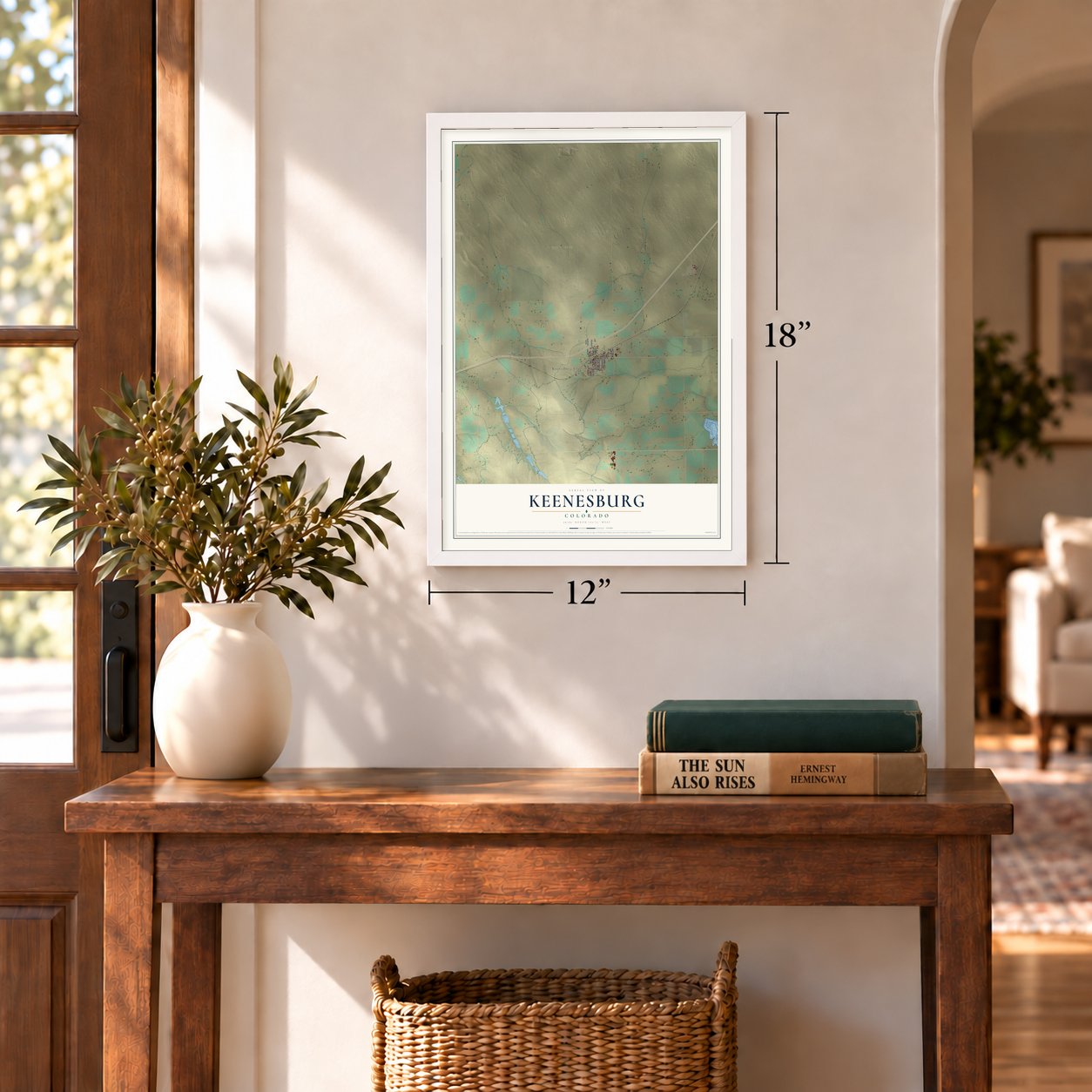 Keenesburg, Colorado map, 12 x 18 inch print in a white frame in an entryway