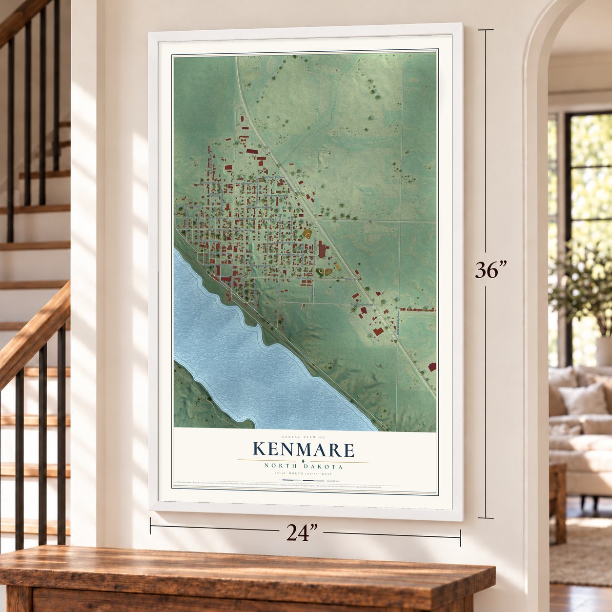 Kenmare, North Dakota map, 24 x 36 inch print in a white frame by a staircase