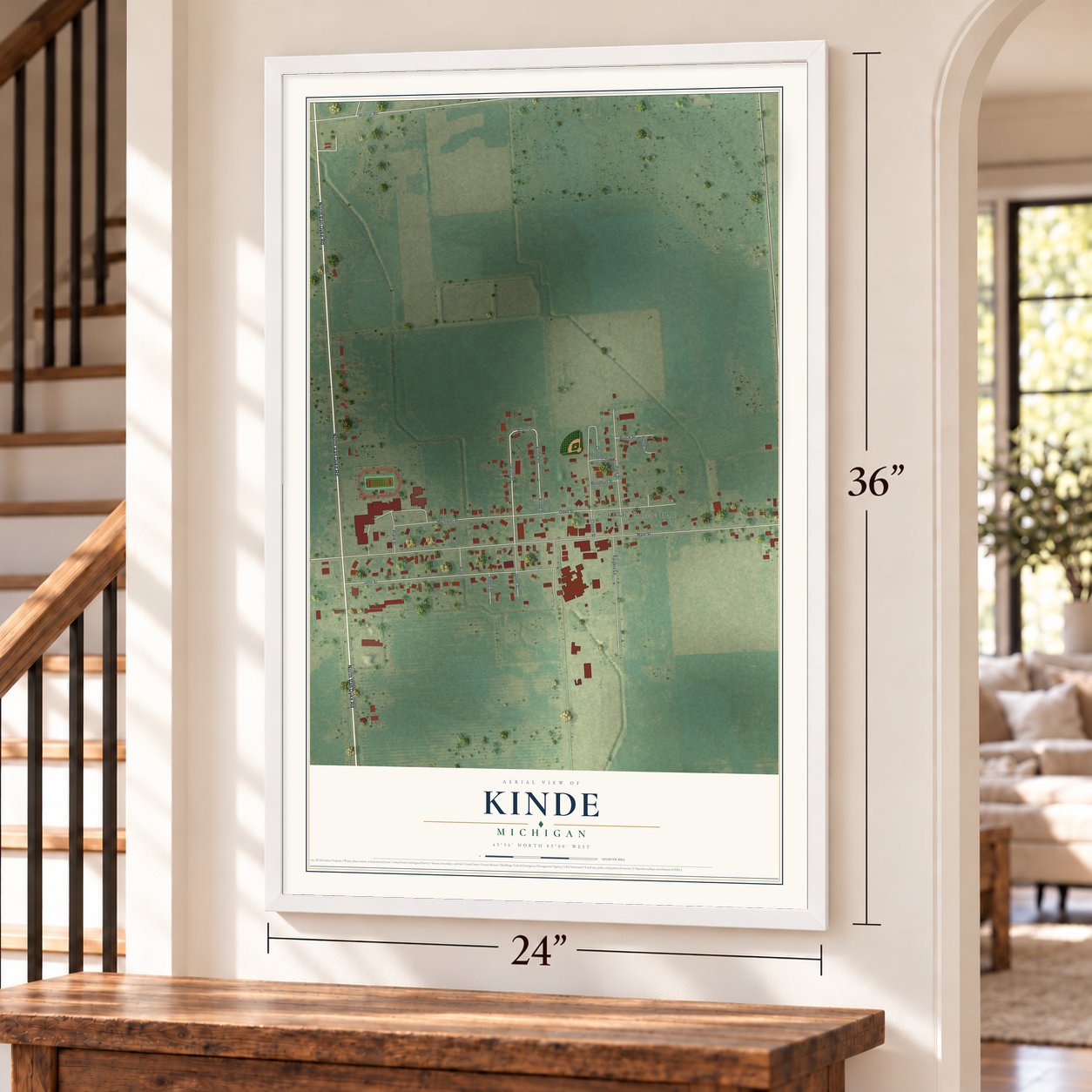 Kinde, Michigan map, 24 x 36 inch print in a white frame by a staircase