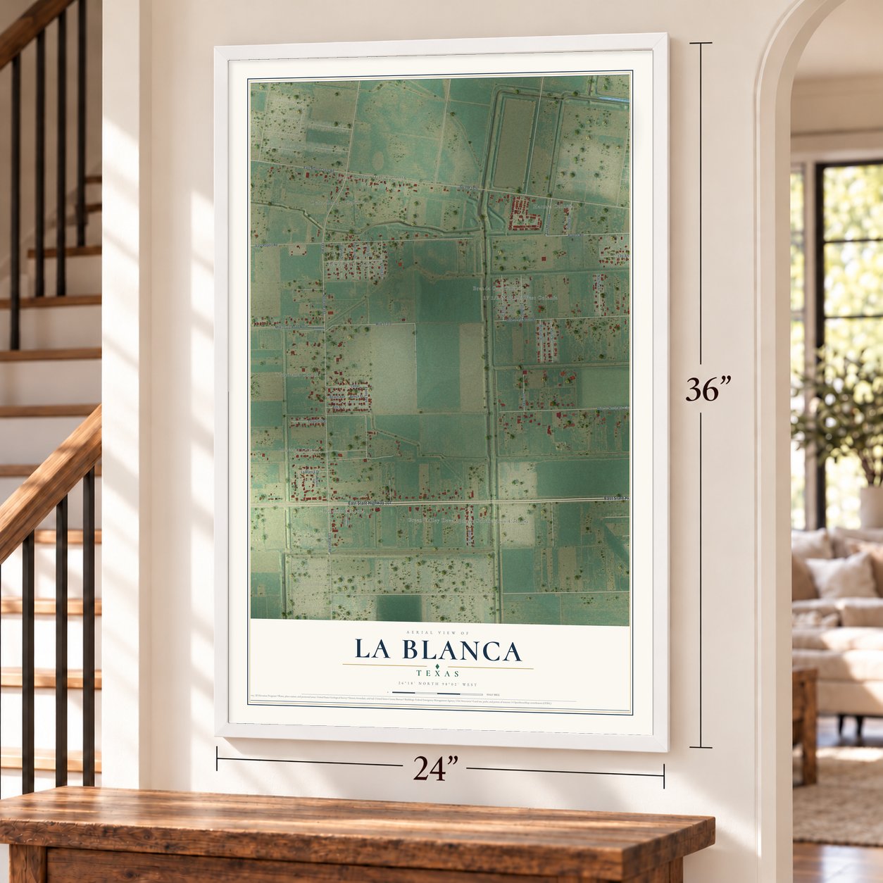 La Blanca, Texas map, 24 x 36 inch print in a white frame by a staircase